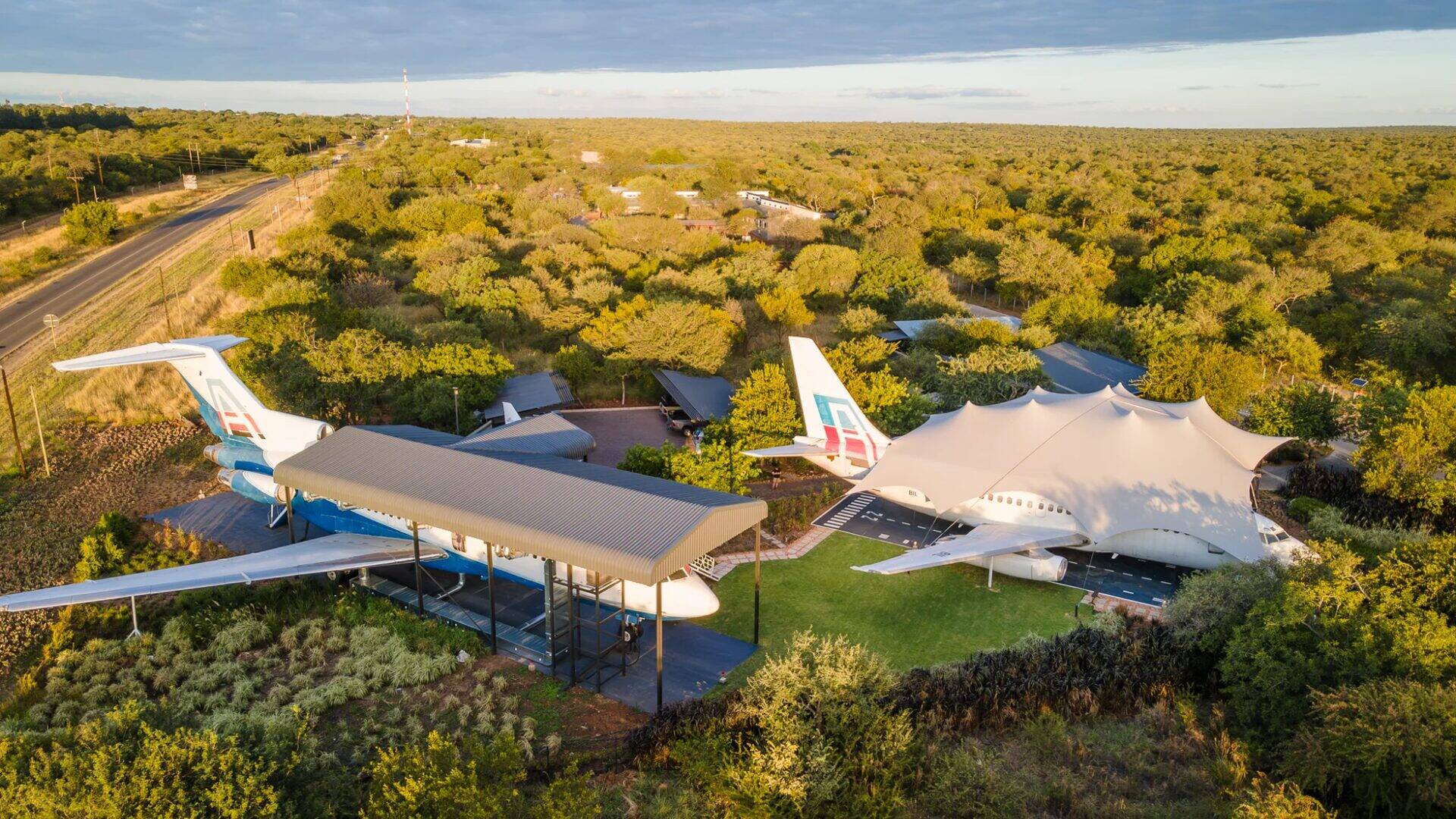 Aerial drone view of Aerotel showing both Boeing 737 and Boeing 727 aircraft surrounded by African bushveld