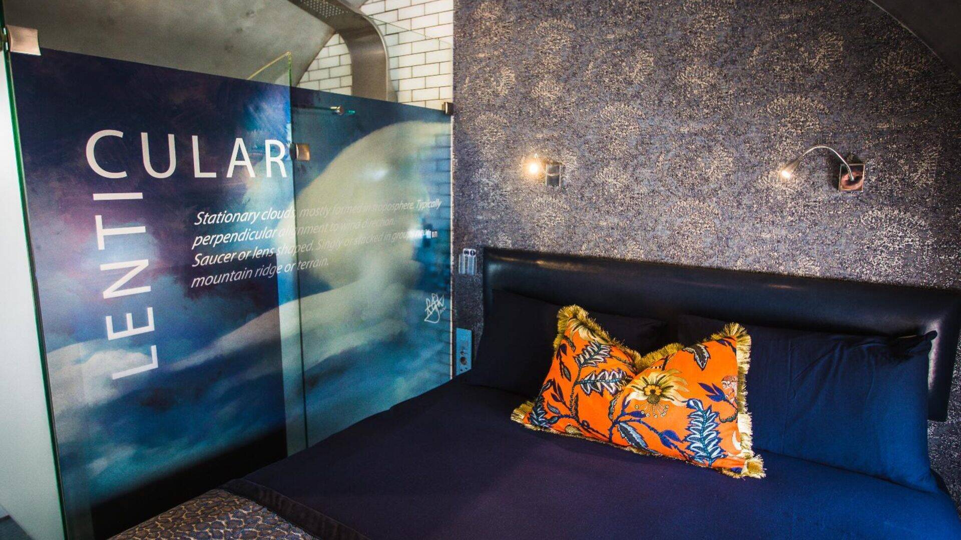 Lenticular cabin interior aboard the Boeing 737 featuring cloud-themed decor, luxury bedding and curved aircraft ceiling